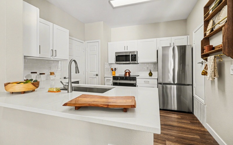 A kitchen with white cabinetry 