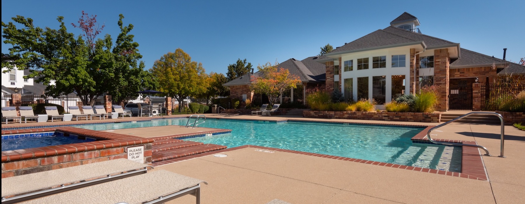 a pool with lounge chairs