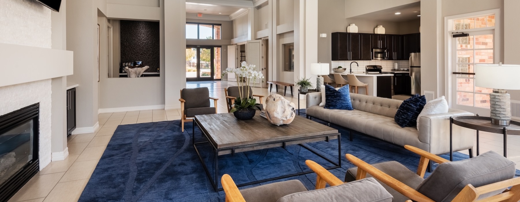a clubroom with a tv, chairs, a table and a couch