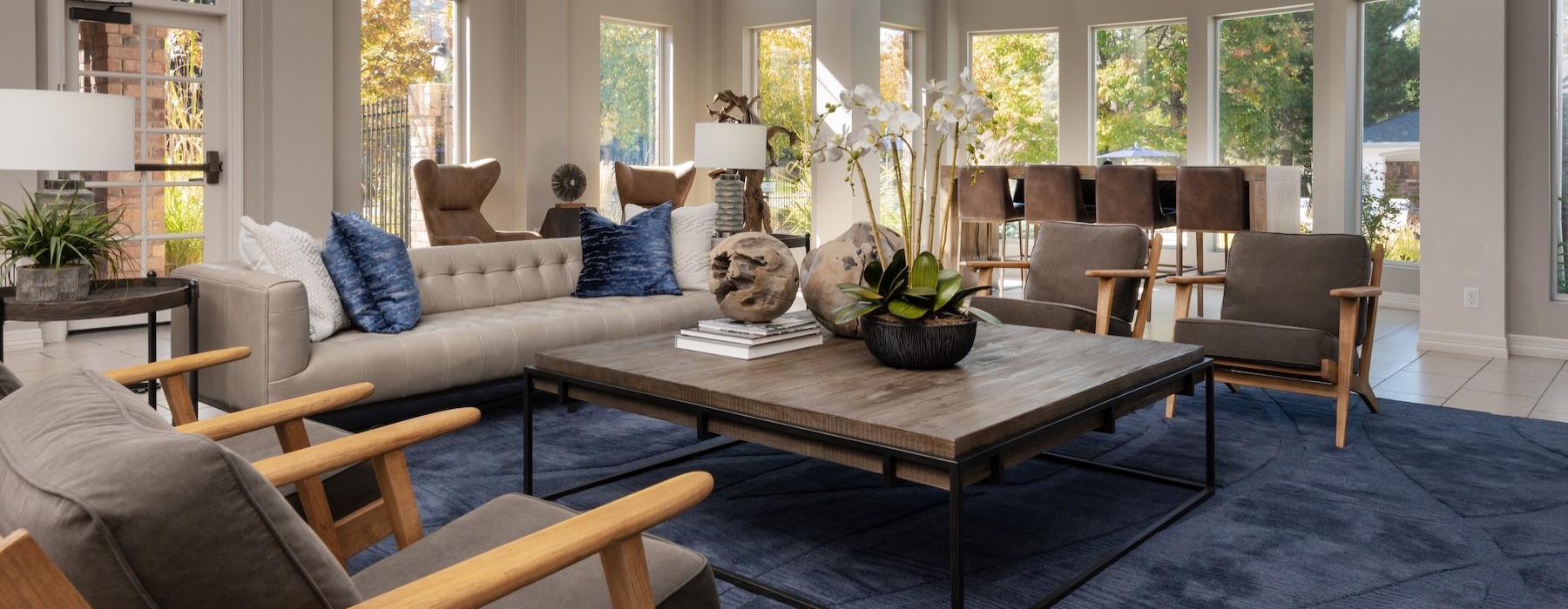 a clubroom with a couch, table and chairs